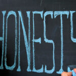 The word 'honesty' written on a chalkboard
