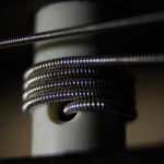 Extreme close-up of a guitar peg with a guitar string passing through it and wrapped around it