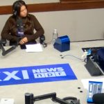 Four people seated around a table for a podcast conversation.